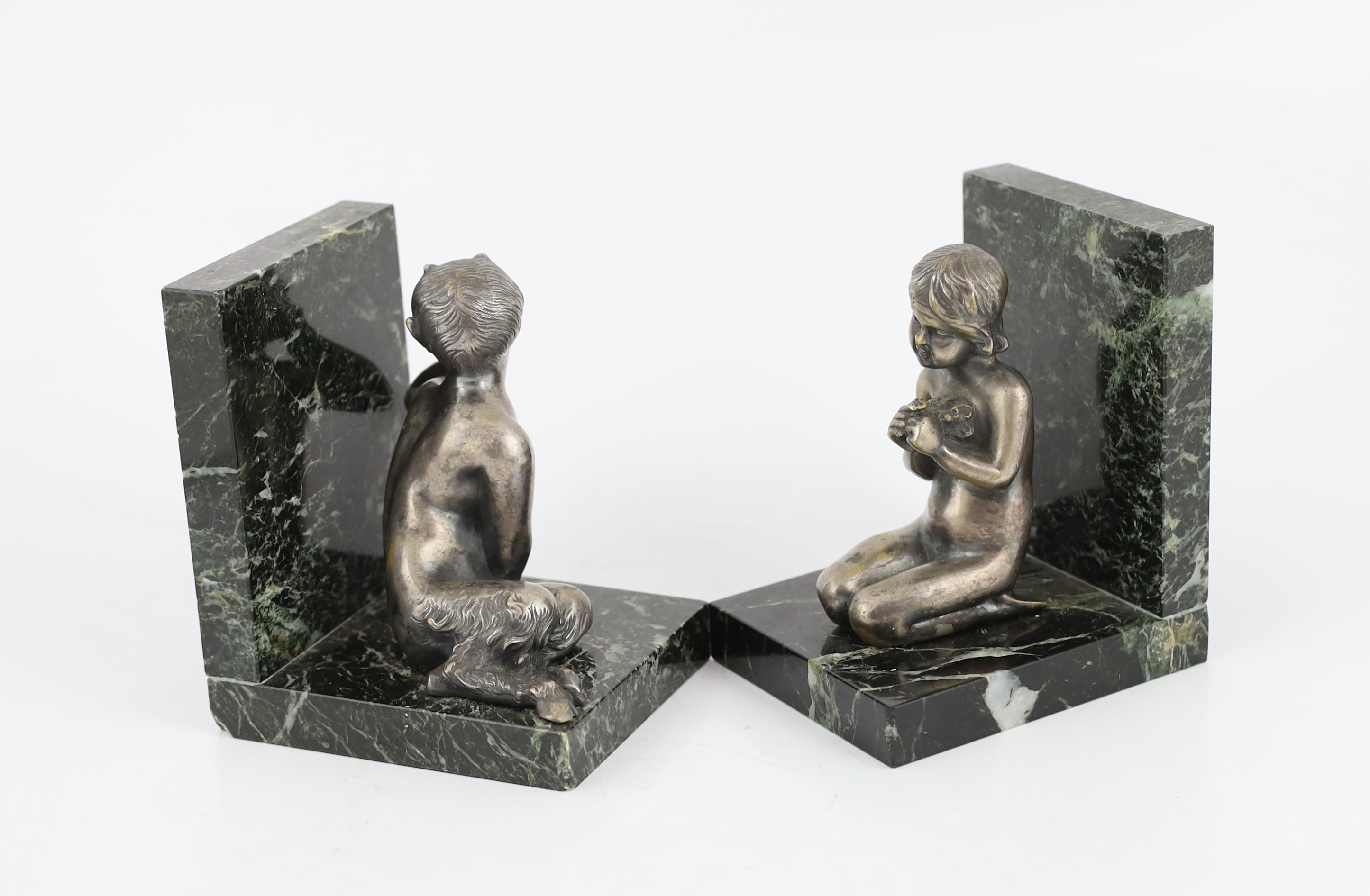 Henri Fugère, a pair of silvered bronze and marble bookends modelled as a kneeling faun and girl holding a posy of flowers, 11cm wide, 9cm deep, 13cm high